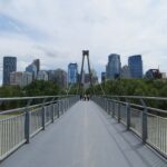 A pedestrian bridge over the Bow River leading toward downtown Calgary
