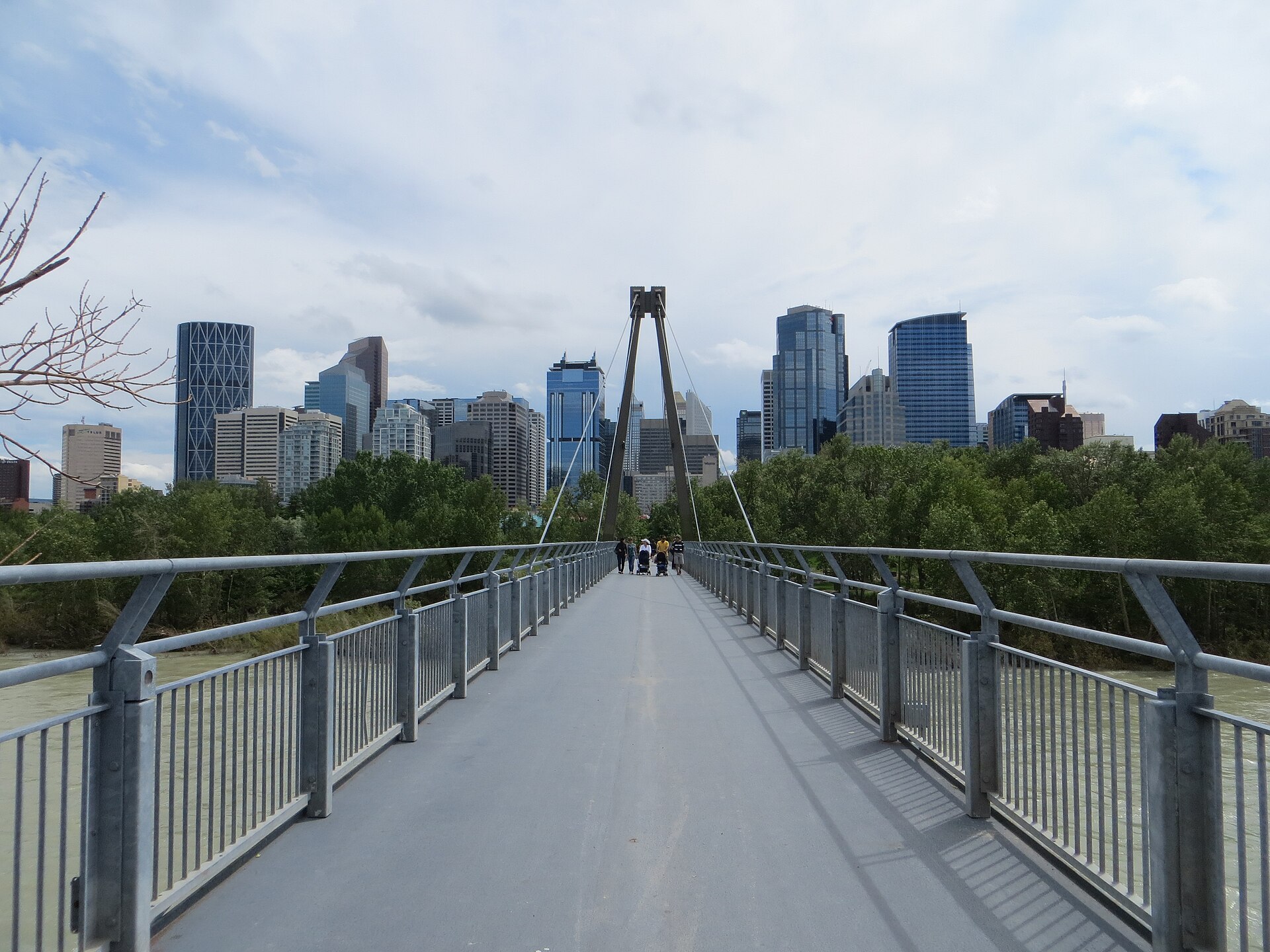 A pedestrian bridge over the Bow River leading toward downtown Calgary