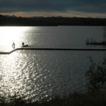 Evening light on the Glenmore Reservoir in Calgary, with a dock silhouetted on the water