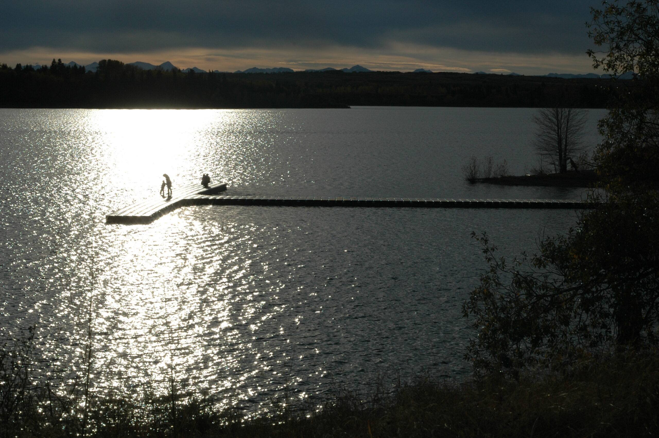 Evening light on the Glenmore Reservoir in Calgary, with a dock silhouetted on the water